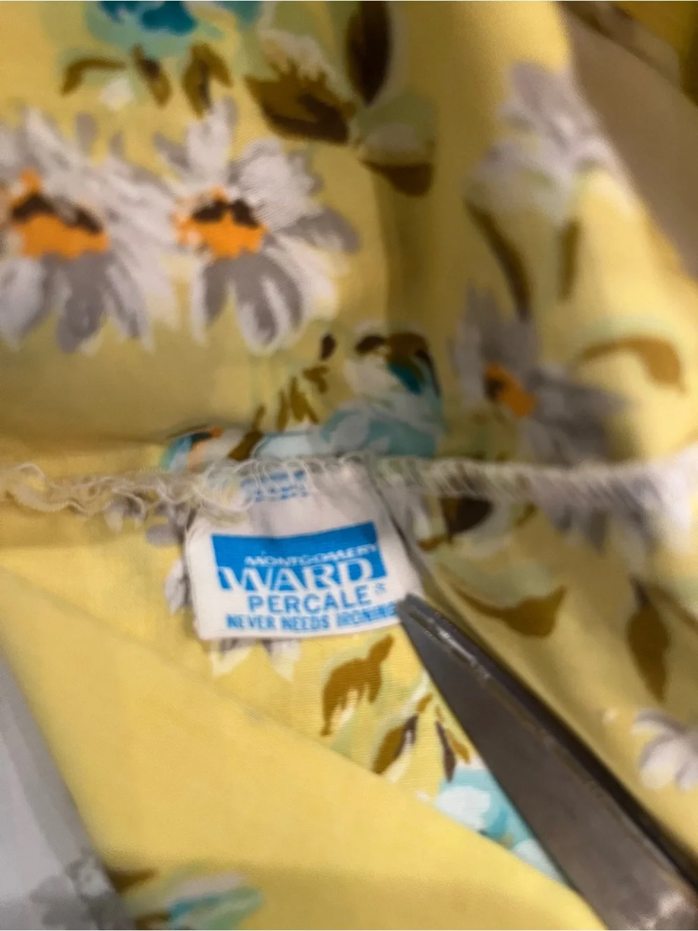 Vintage Montgomery Ward cream floral pillow case with yellow edge accent.